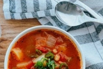 minestrone soup in bowl with spoon