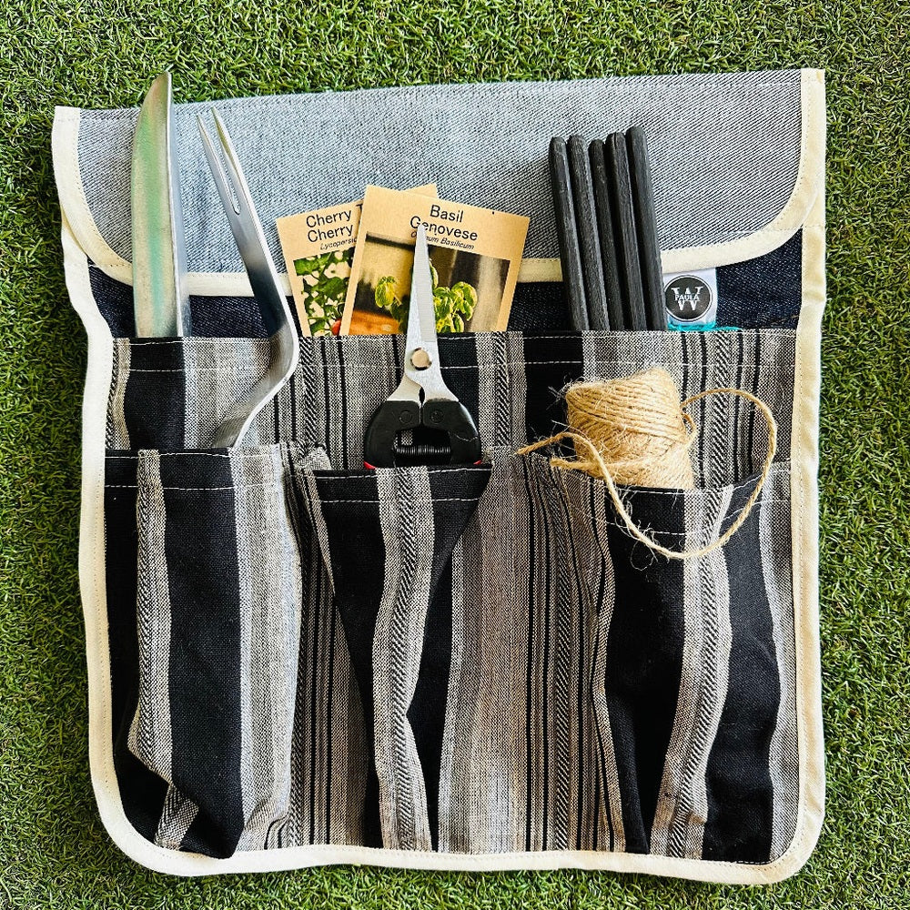 Gardening Tool Pouch with Compartments Holding Tools and Supplies on a Grass Background.