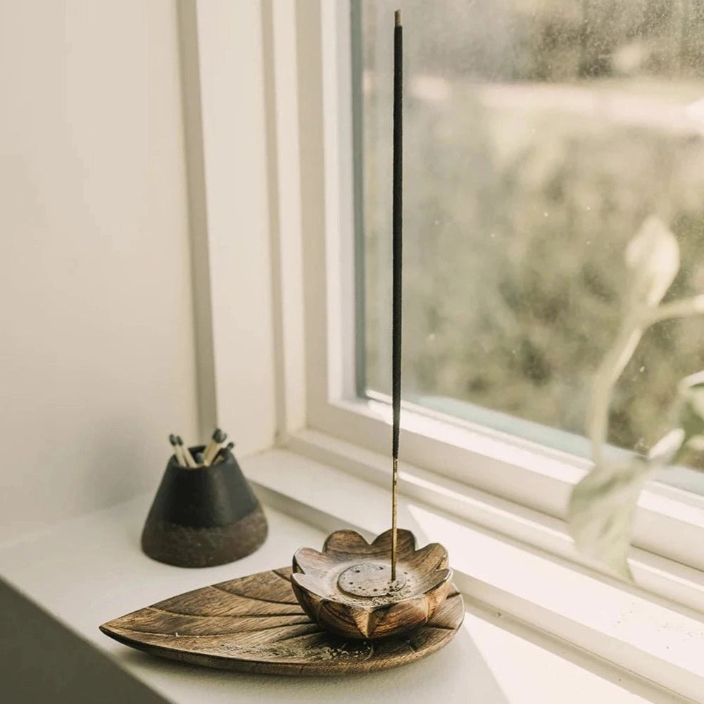 Lotus Wooden Incense Holder with Incense Stick in Window.