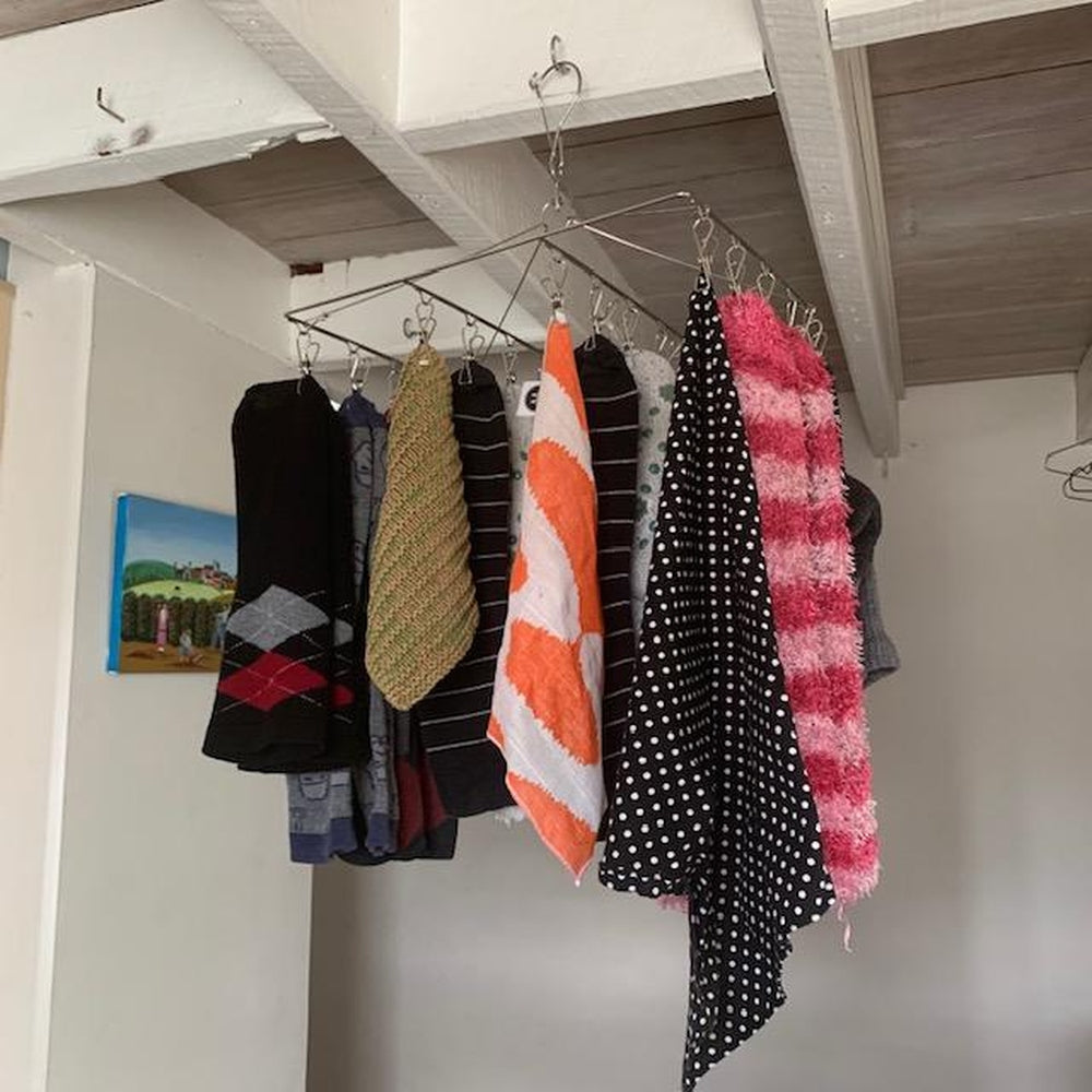 Urban Revolution's Own Stainless Steel Peg Hanger with small items on it.