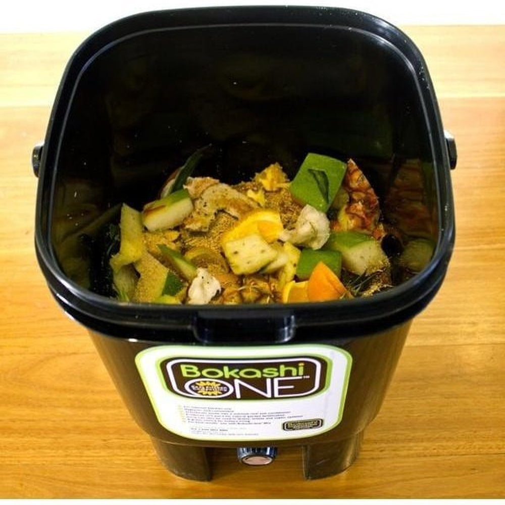 Open Black Bokashi Bucket Showing Food Scraps Inside