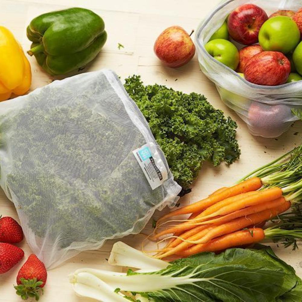 Two ONYA Produce Bags with a Variety of Vegetables and Fruits