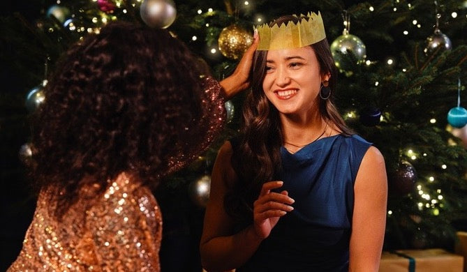 Two ladies next to Christmas Tree