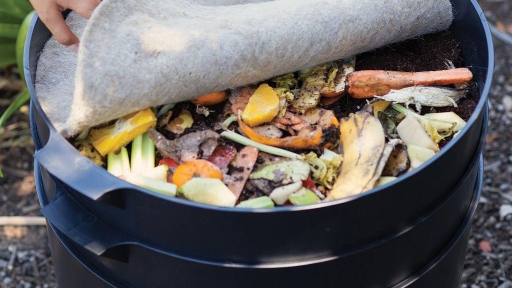 Food scraps under a compost blanket