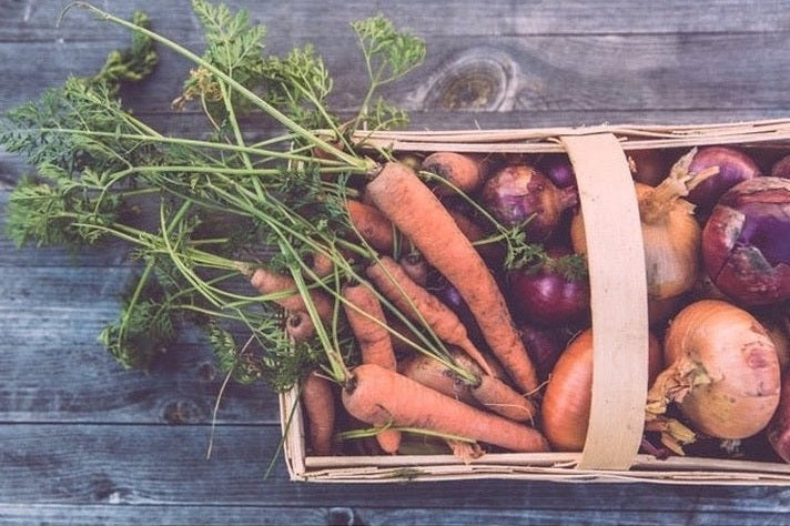 basket of vegetables on a bench