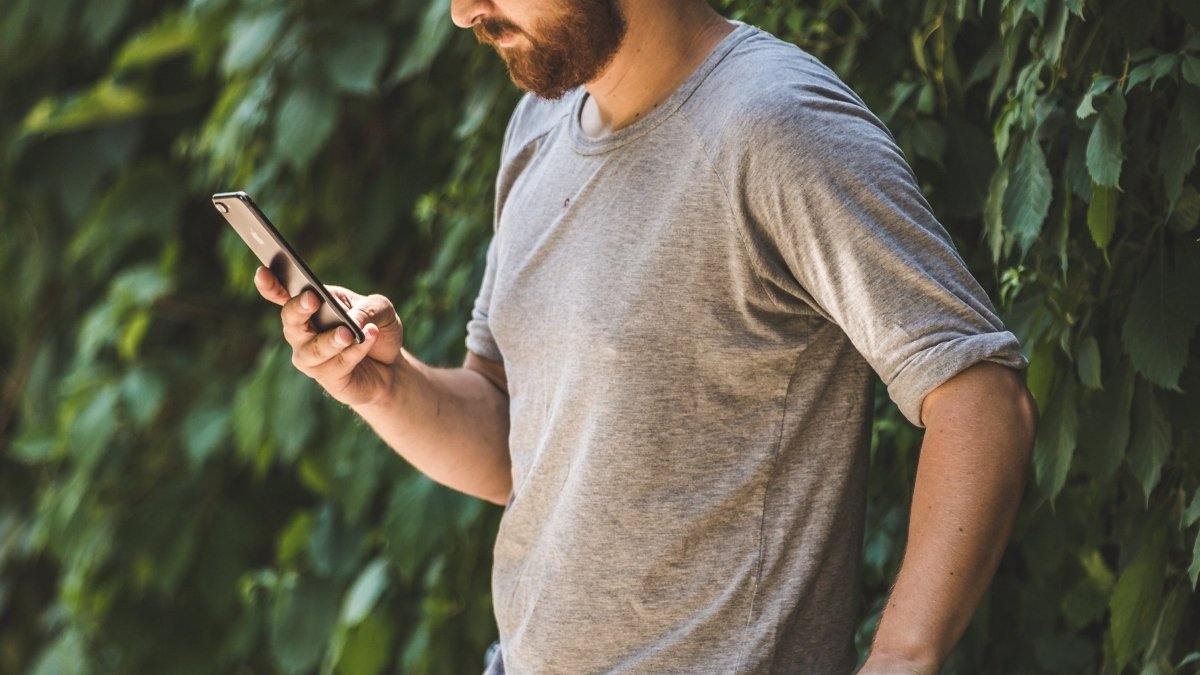 Man holding phone in the garden