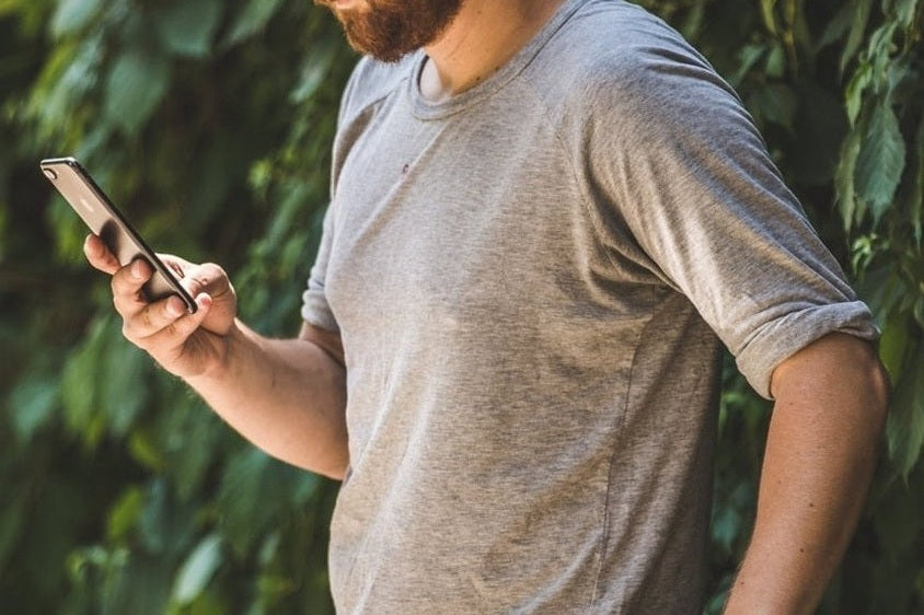 Man holding phone in the garden