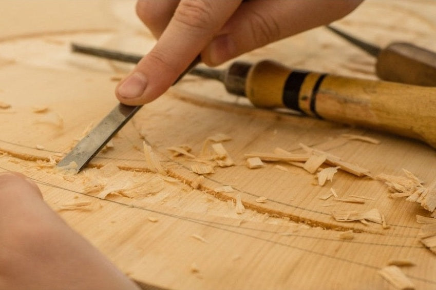 Hands demonstrating carpentry with hand tools