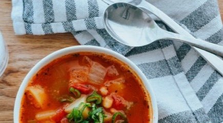 minestrone soup in bowl with spoon