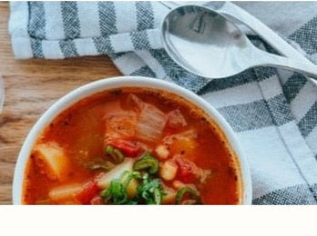 minestrone soup in bowl with spoon