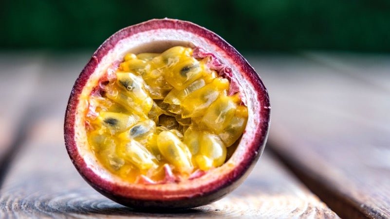 Passionfruit cut in half on wooden bench