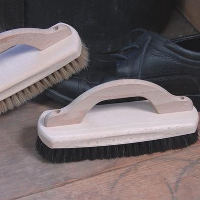 Natural Fibre Shoe Brush with Wood Handle next to black shoes