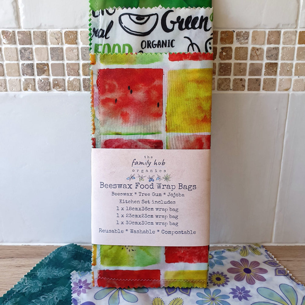 Set of Colorful Beeswax Food Wrap Bags with a Label on a Tiled Wall Background.