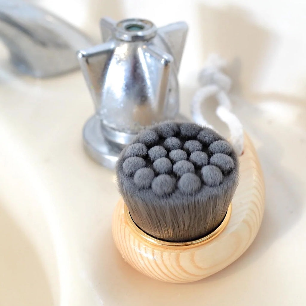 Bamboo face cleansing and makeup removal brush with ultra fine charcoal infused silk fibres.