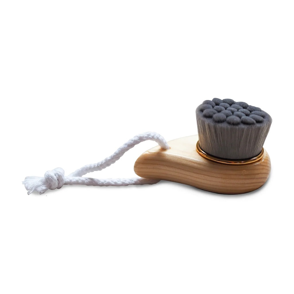 Bamboo face cleansing brush with charcoal infused silk fibres.