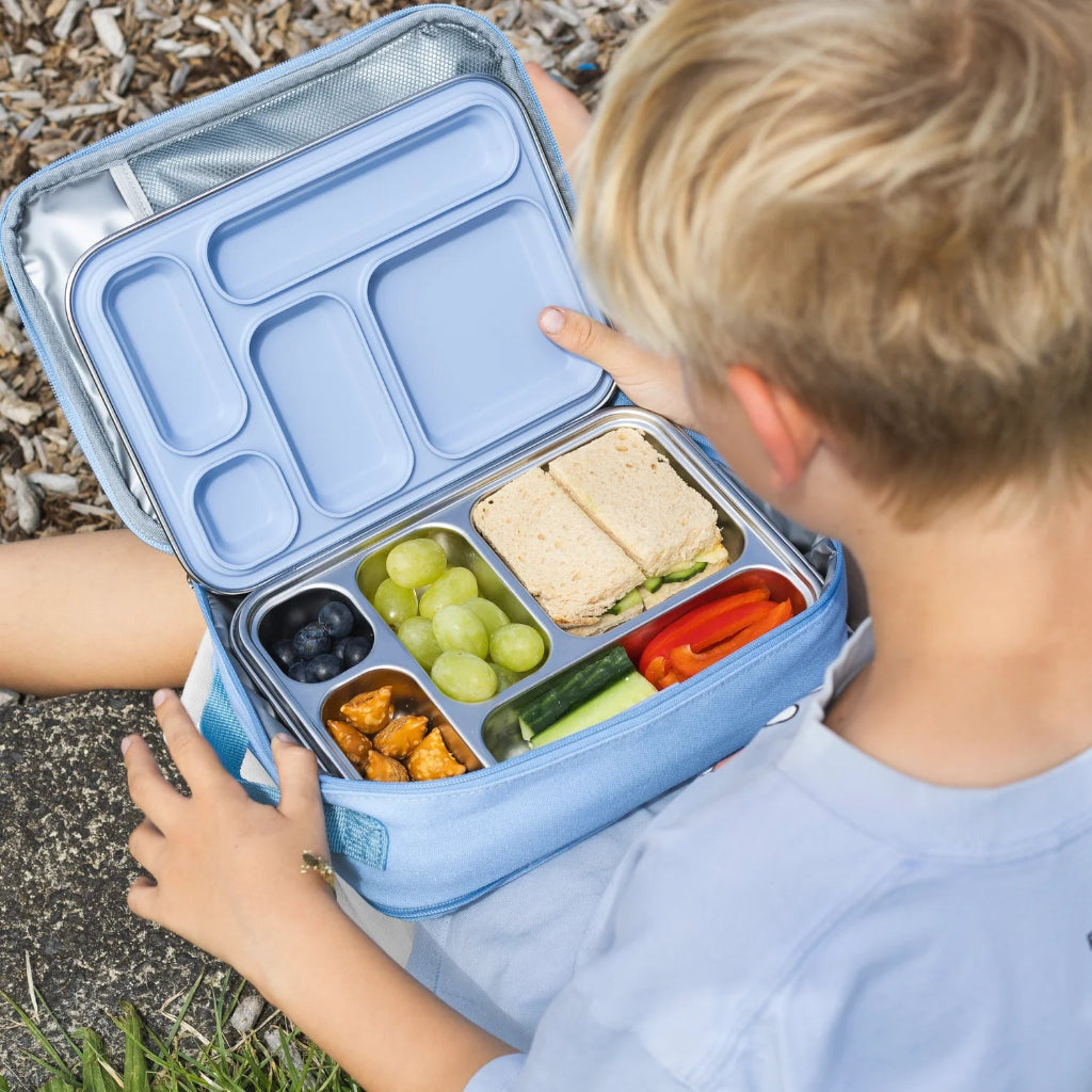 Child Sitting with Ever Eco 5 Compartment Stainless Steel  and Silicone Bento Lunch Box Filled with Snacks in Cove Blue Colour.