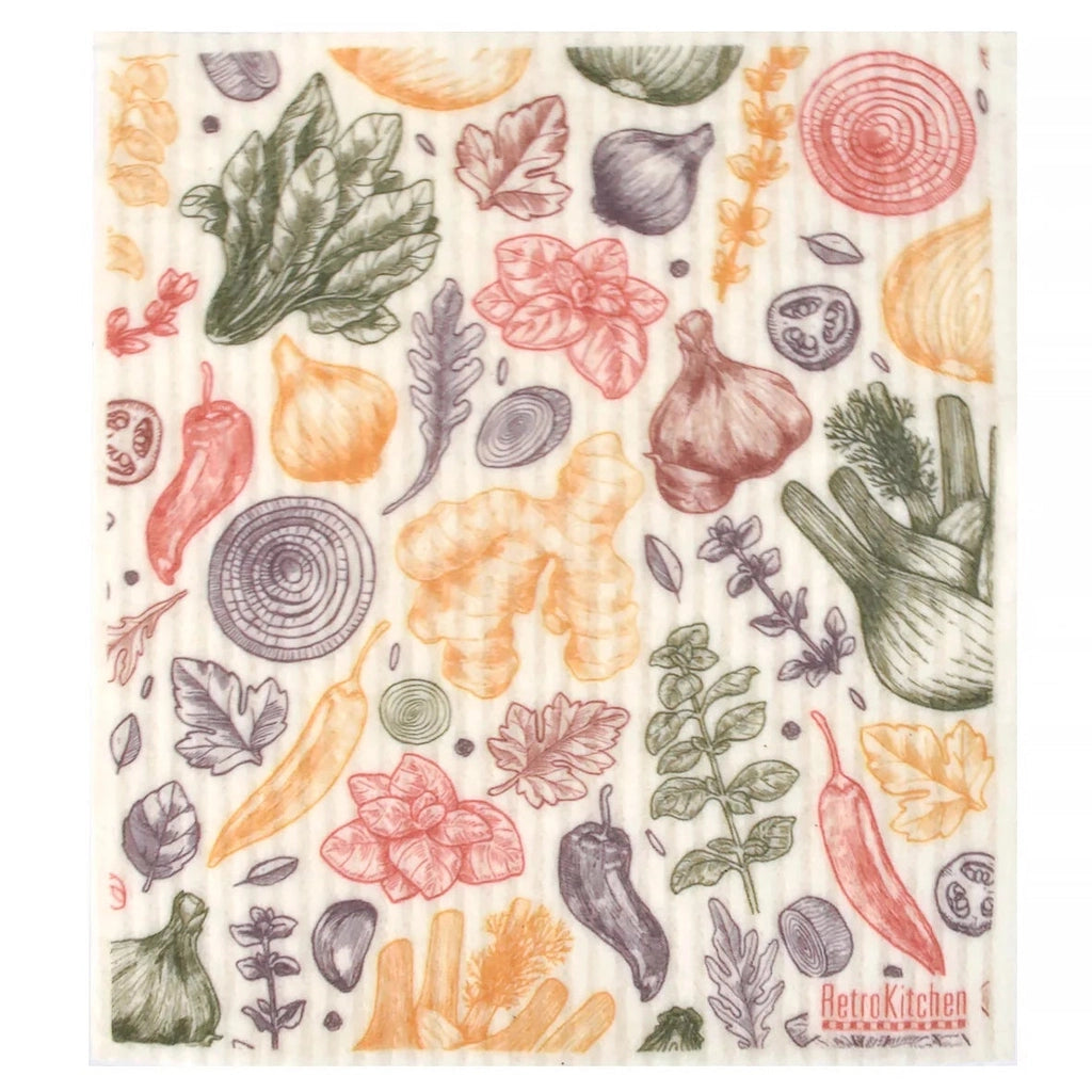 A rectangular kitchen dishcloth with a white background and a colourful pattern of various vegetables and herbs, including carrots, onions, peppers, and leafy greens.