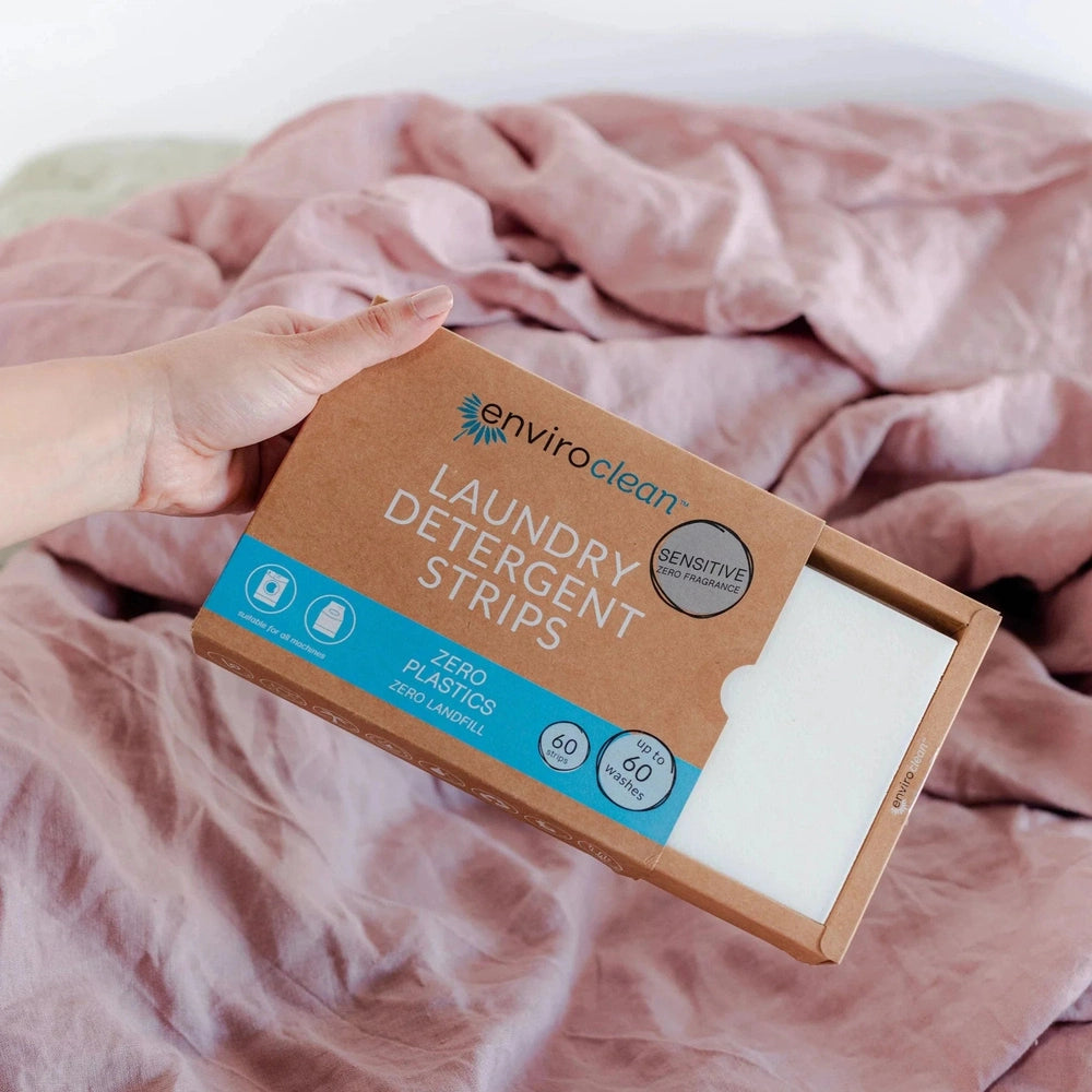 Hand Holding Open Box of Enviroclean Fragrance Free Laundry Detergent Strips, Urban Revolution.