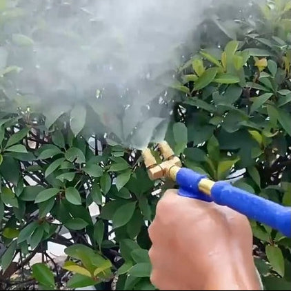 Person misting using a blue sprayer with brass nozzle