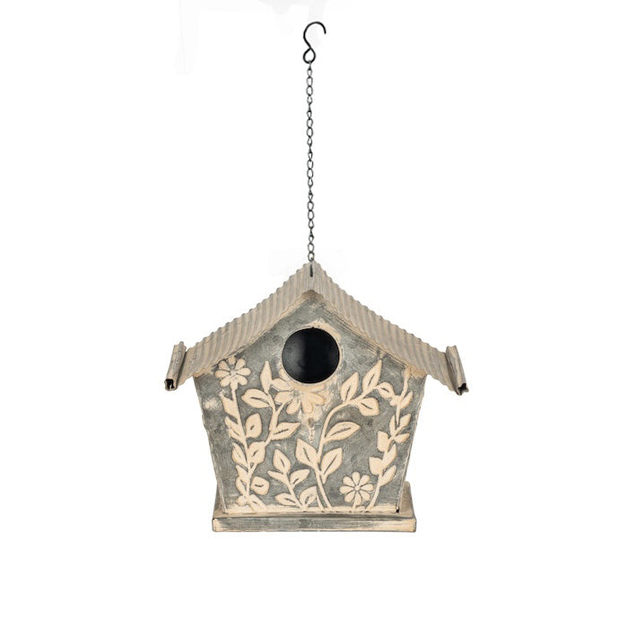 Decorative Birdhouse with Floral Patterns on a White Background.
