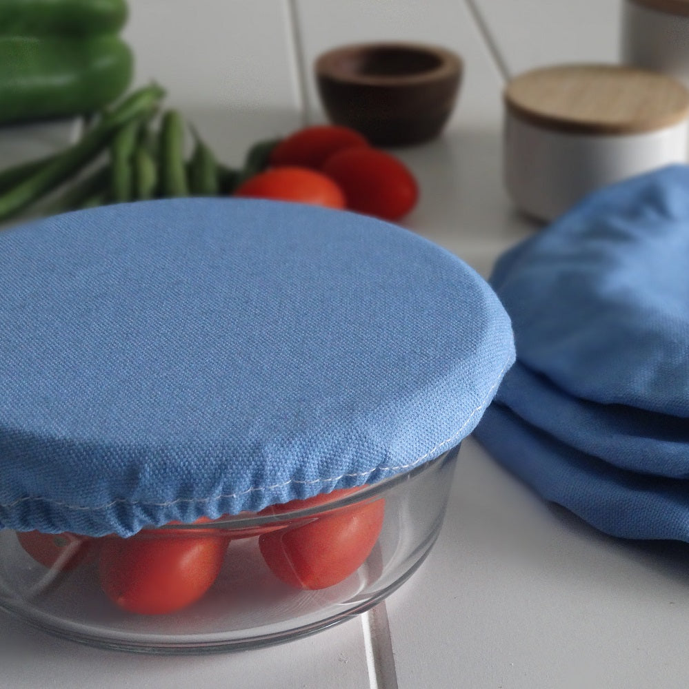 Blue Denim fabric covers on glass containers with tomatoes and green beans in the background