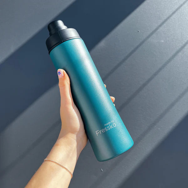 A Hand Holding the Move Insulated 660ml Drink Bottle, from Fressko in Emerald - Urban Revolution