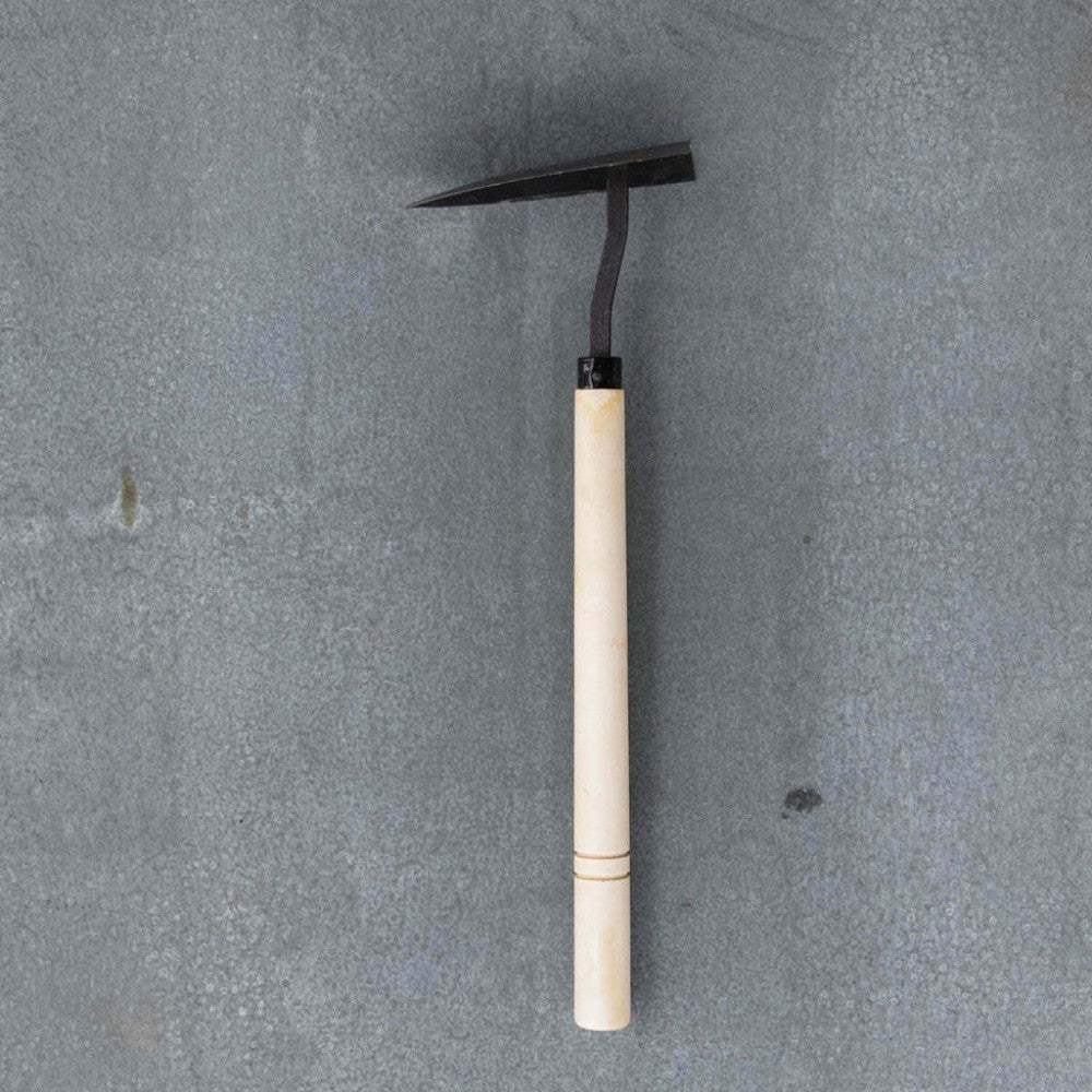 Small gardening tool with a wooden handle on a gray background