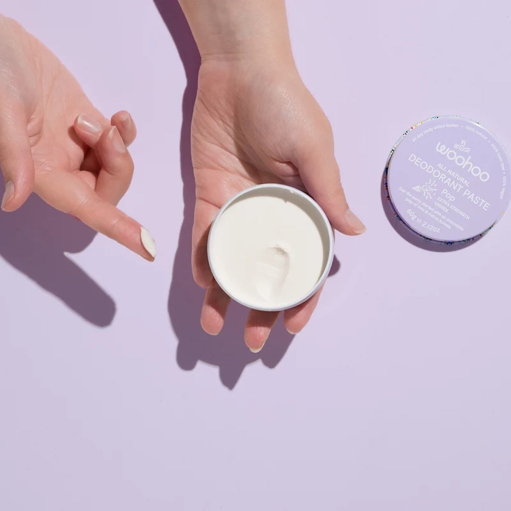 Person using Woohoo All Natural Deodorant paste in Pop scent
