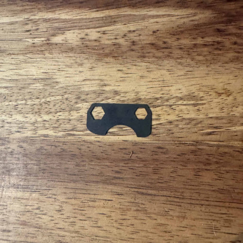 Black metal socket tool on a wooden surface