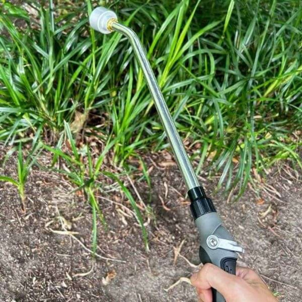 Garden sprayer held over green plants
