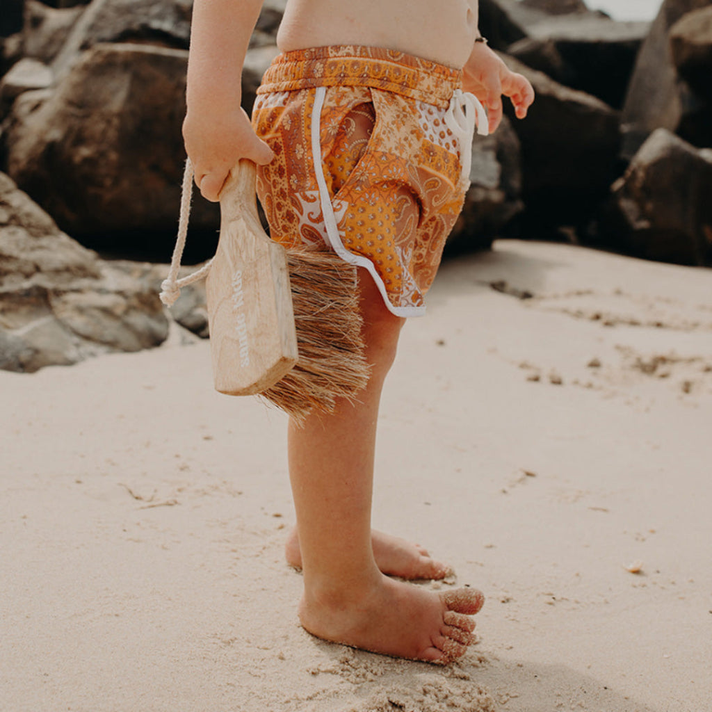 Child Carrying Eco Max Sand Brush at the Beach.