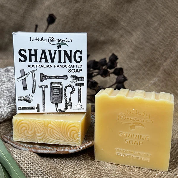 Two bars of Uthly Organics shaving soap with packaging and one without.