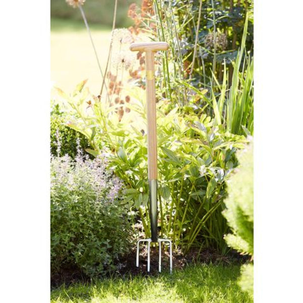 Sophie Conran Garden Fork with Wooden T-Handle and Stainless Steel Head - Shown in Garden.