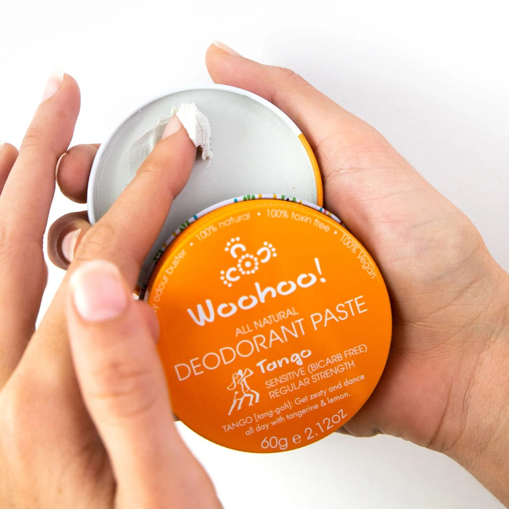 Person using Woohoo All Natural Deodorant Paste in Tango scent