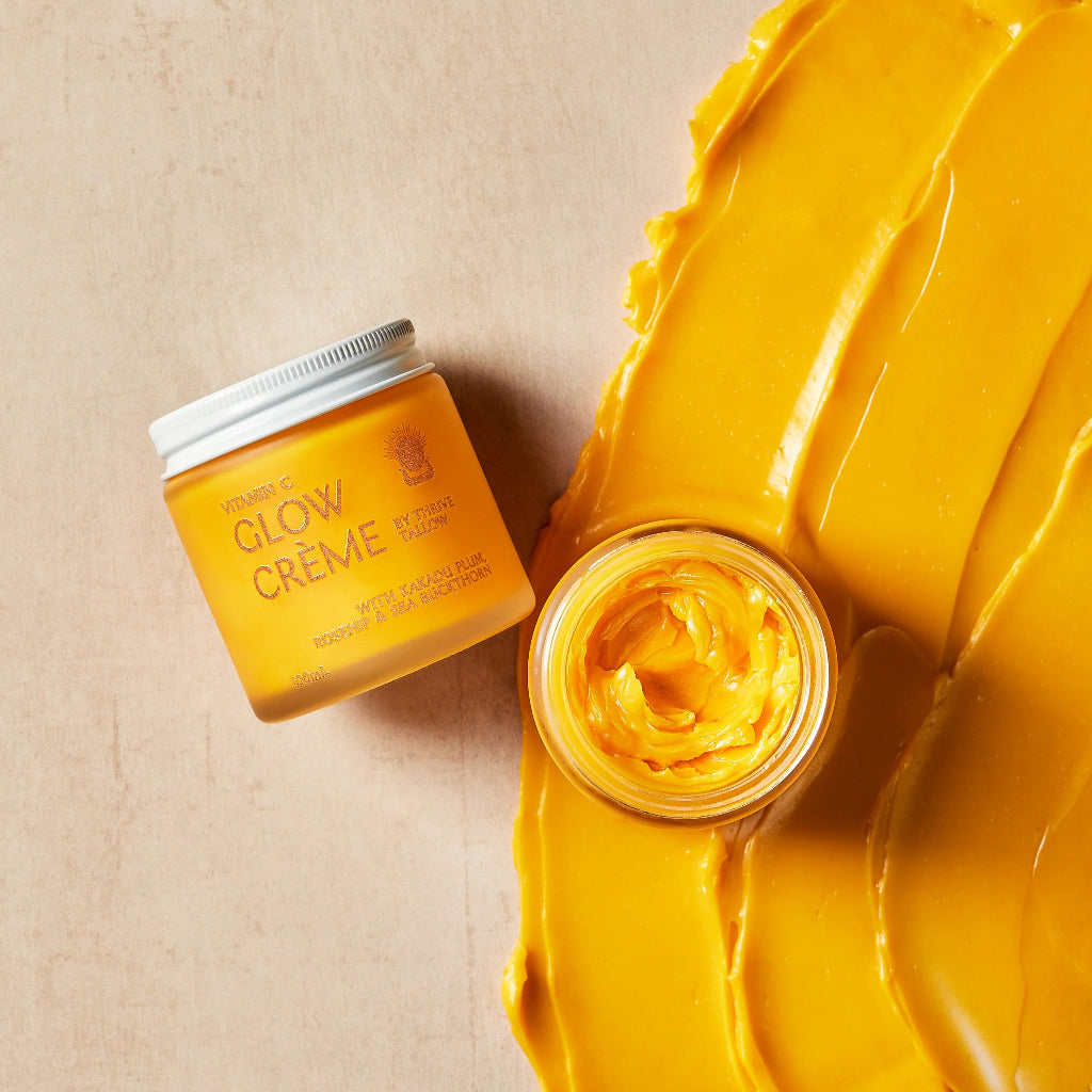 Jar of Thrive Tallow Vitamin C Glow Crème. with a swatch of Glow Creme on a Beige Background.