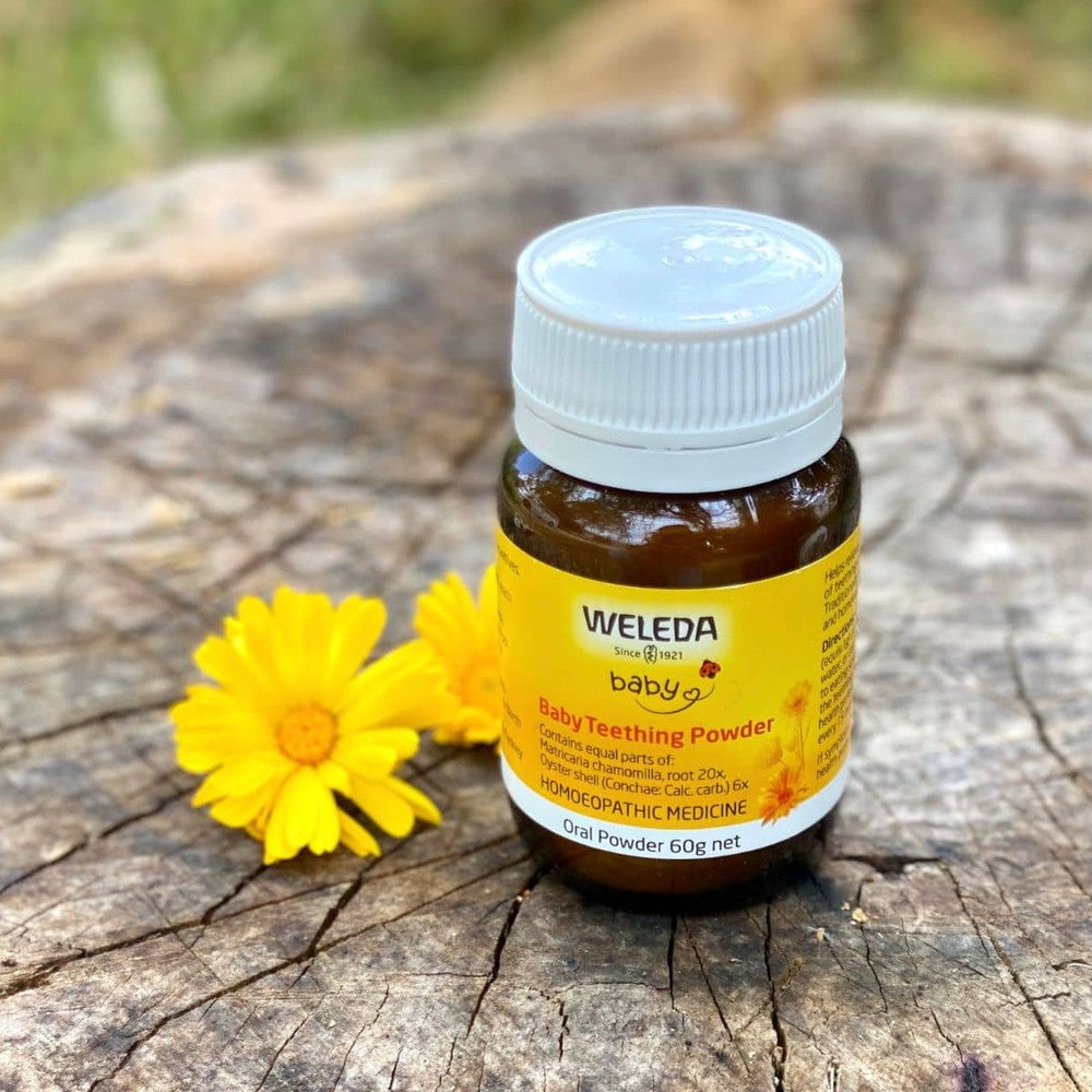 Weleda Baby Teething Powder on wooden tree stump
