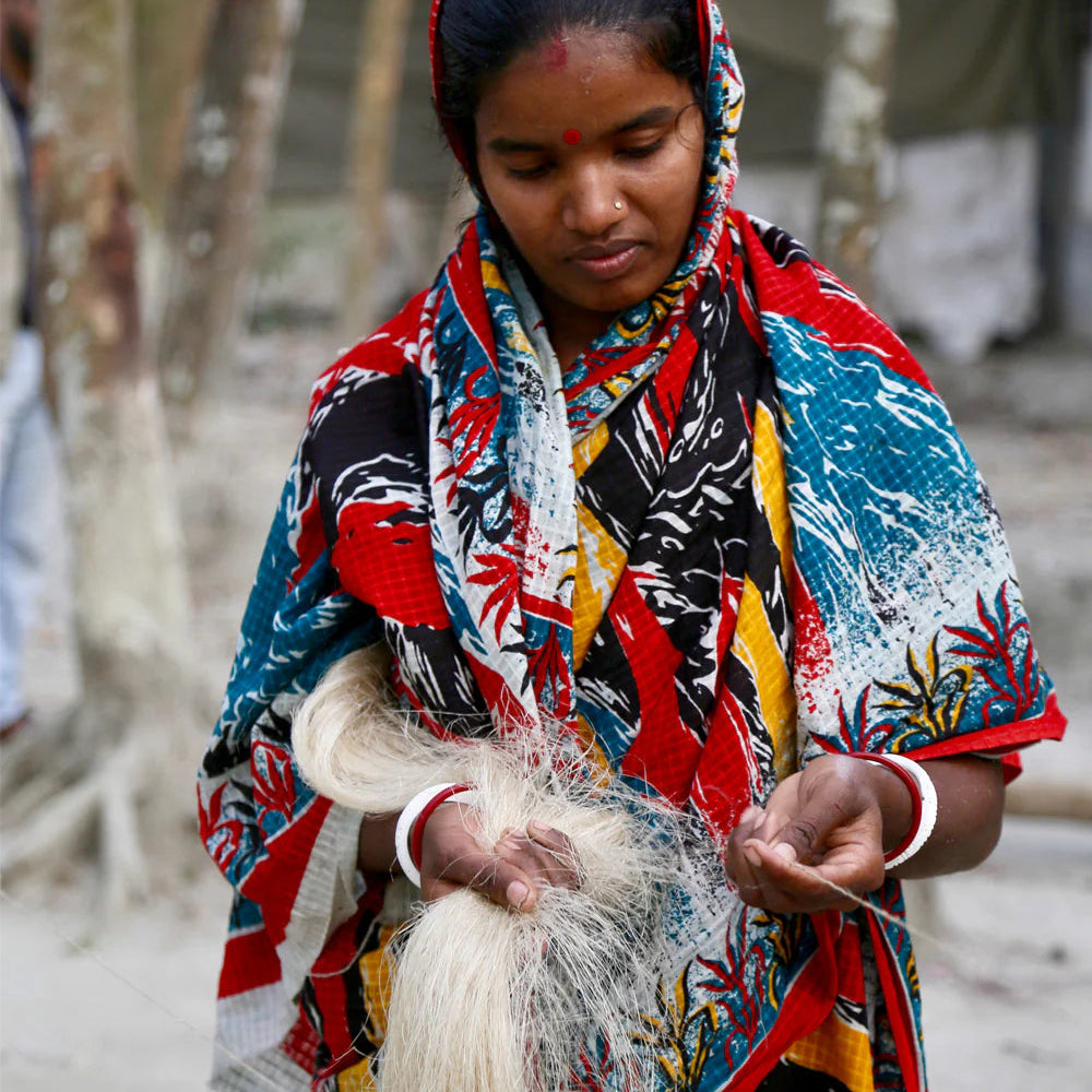 Woman in Bangladesh Spinning Jute Fibres.