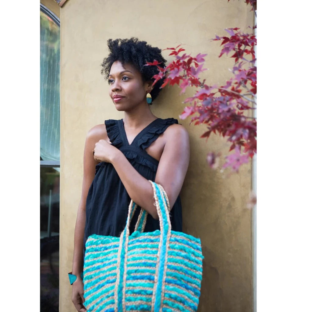 Woman Holding Fair Trade Woven Jute and Upcycled Blue Chindi Bag