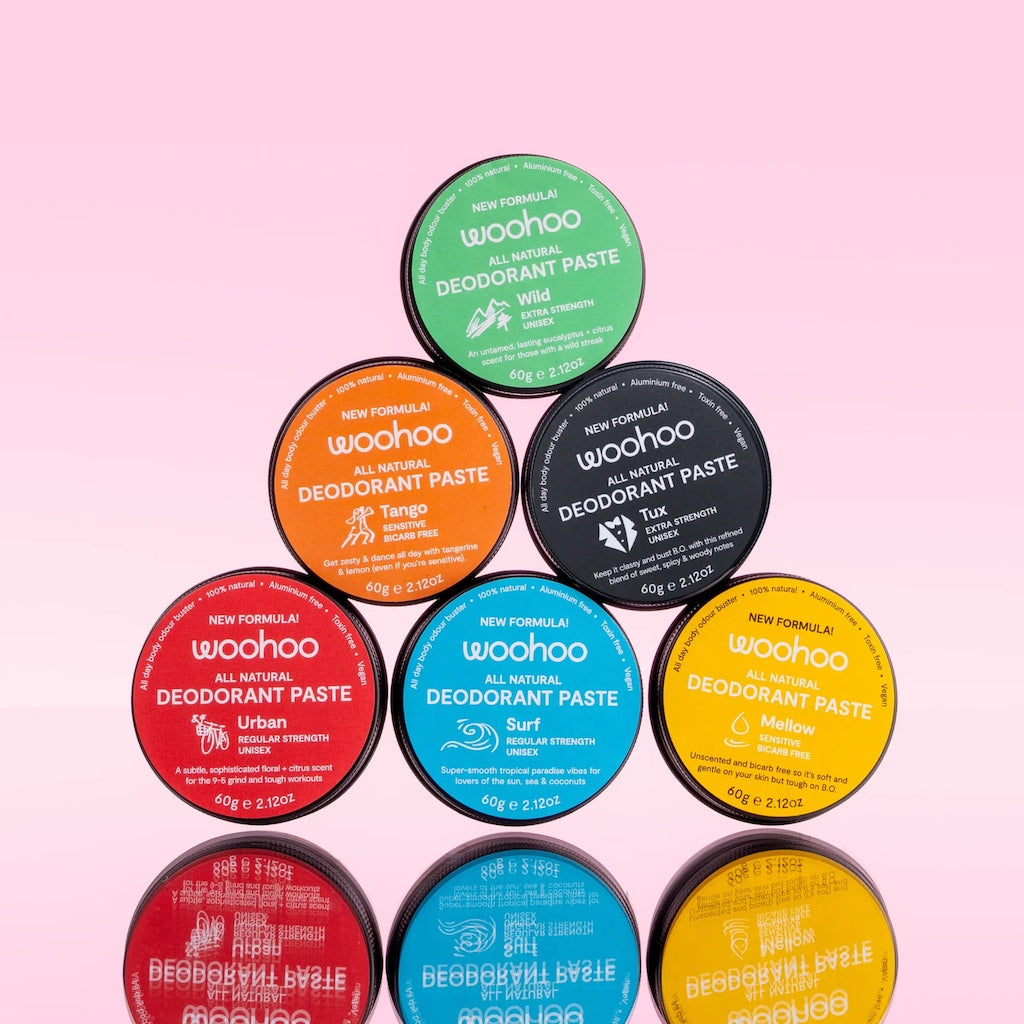 The range of Woohoo all natural deodorant paste tins stacked together in a pyramid shape.