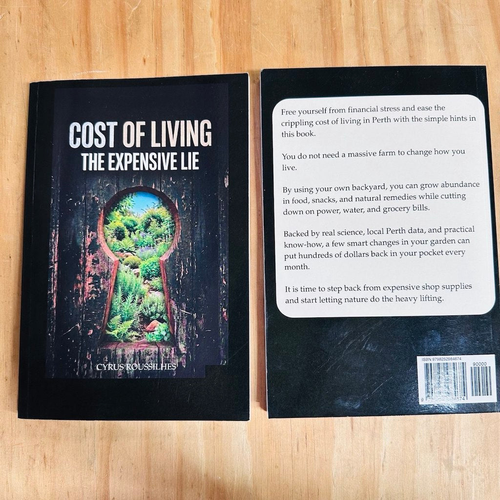 Black book titled 'Cost of Living: The Expensive Lie' by Cyrus Roussilhes is displayed on a wooden background.