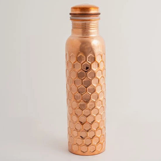 A hammered copper water bottle with a matching copper screw-on lid.