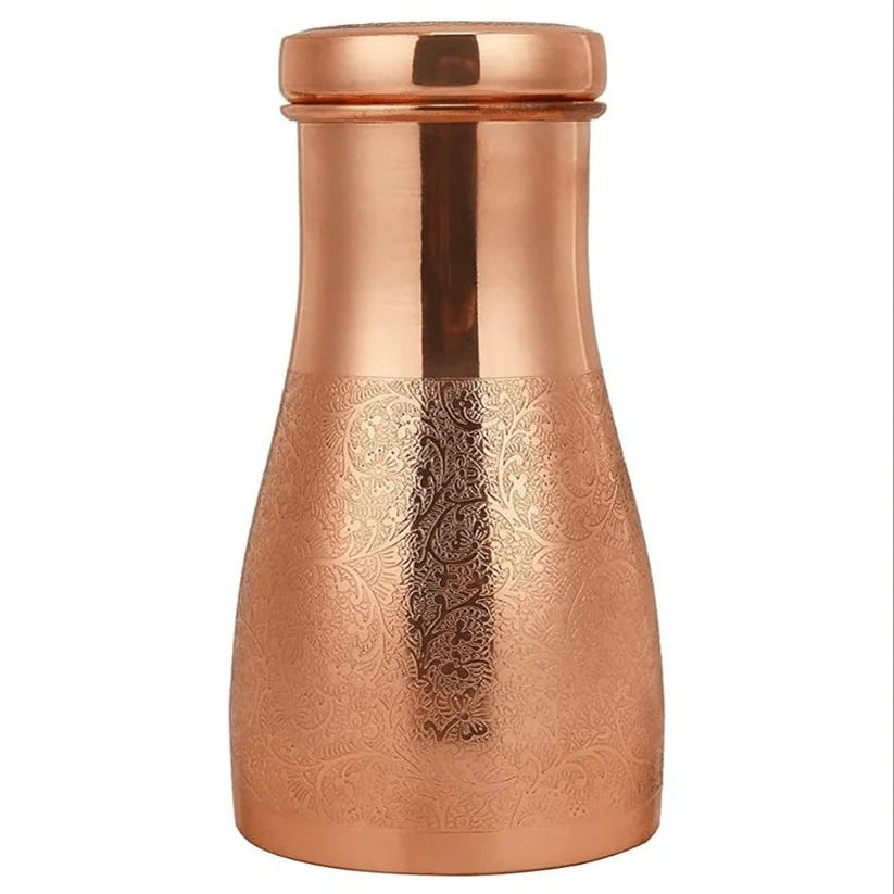 A copper water carafe with a hand-carved design on the body and a smooth lid, shown on a plain white background.
