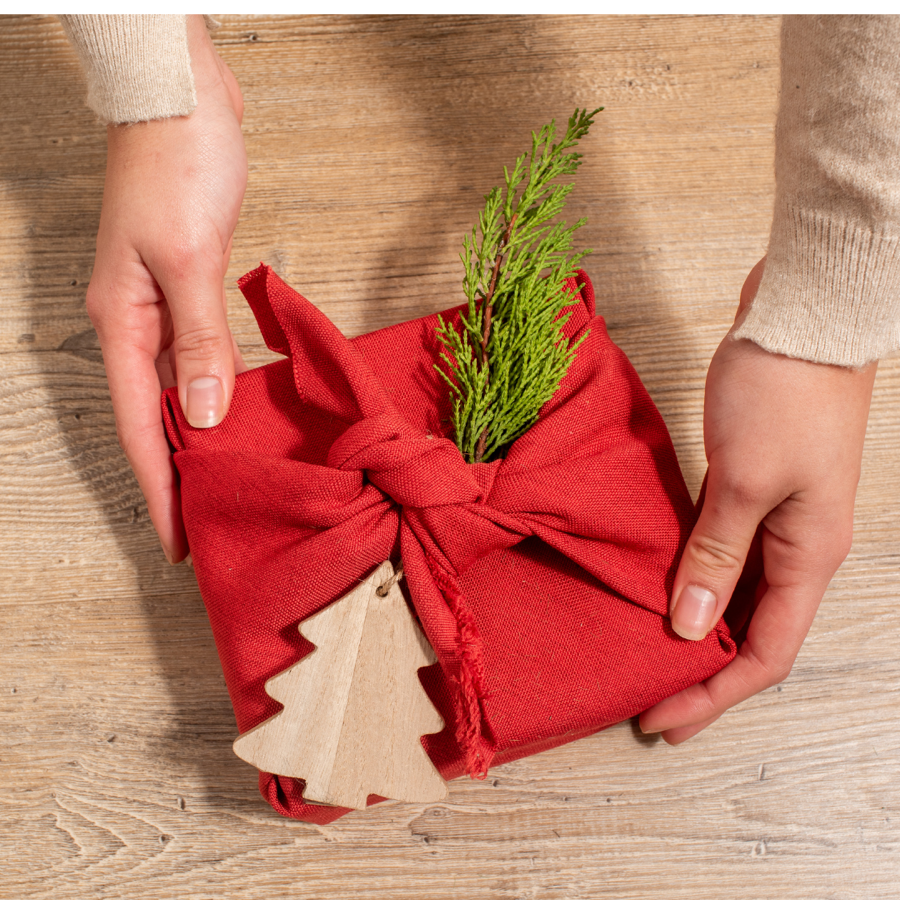 Red furoshiki Christmas wrap with hands
