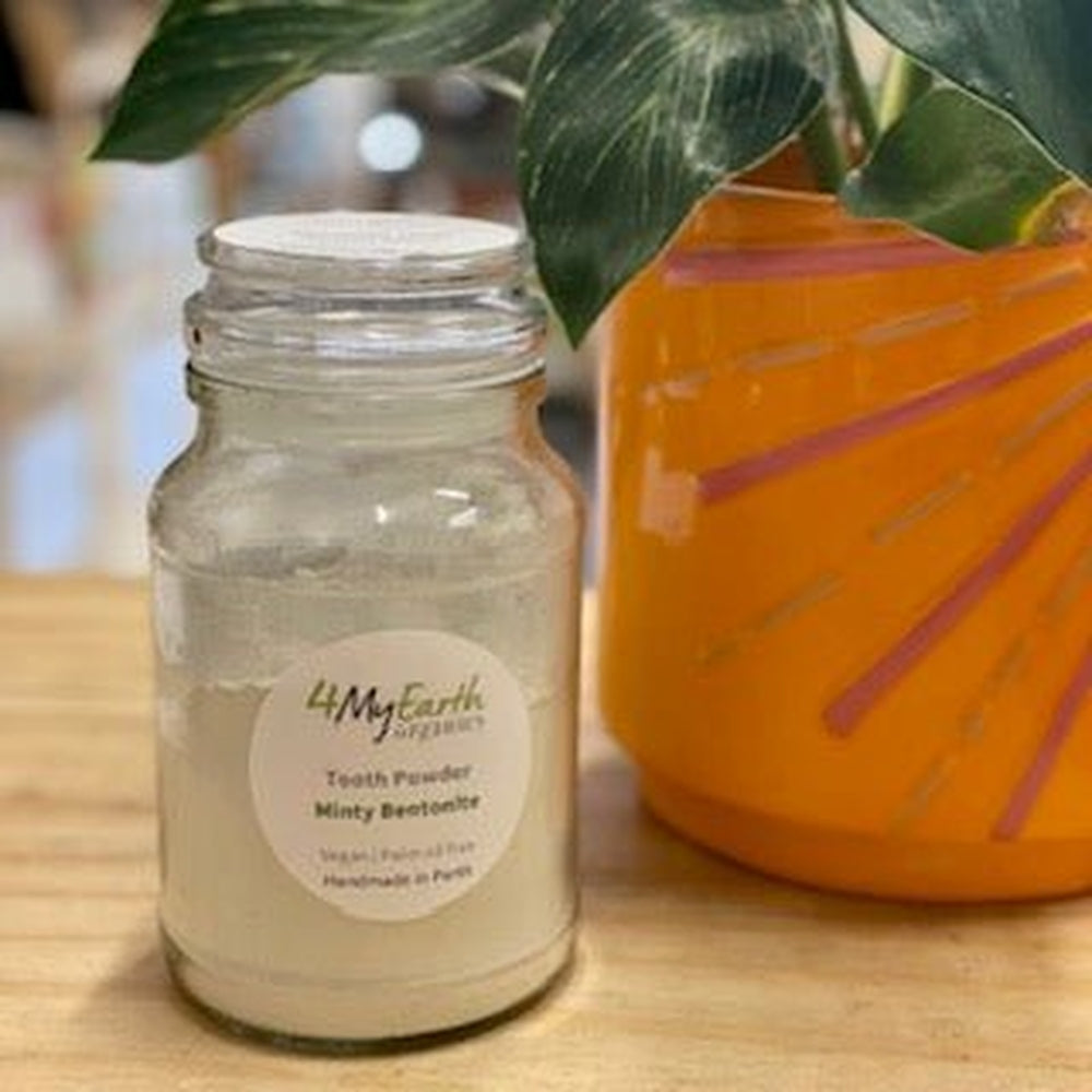 Bentonite tooth powder in a glass jar