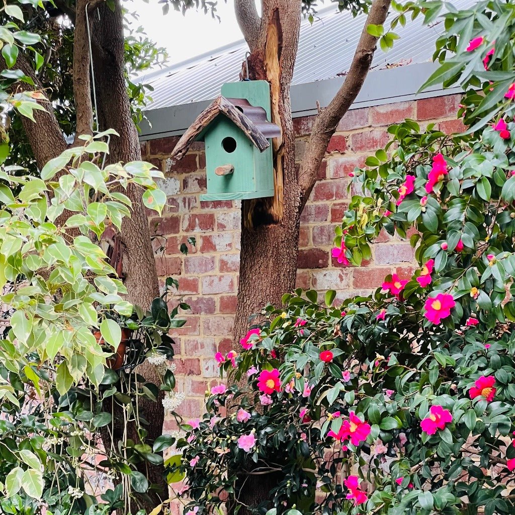 Rustic Handmade Bird House in Tree in Garden.
