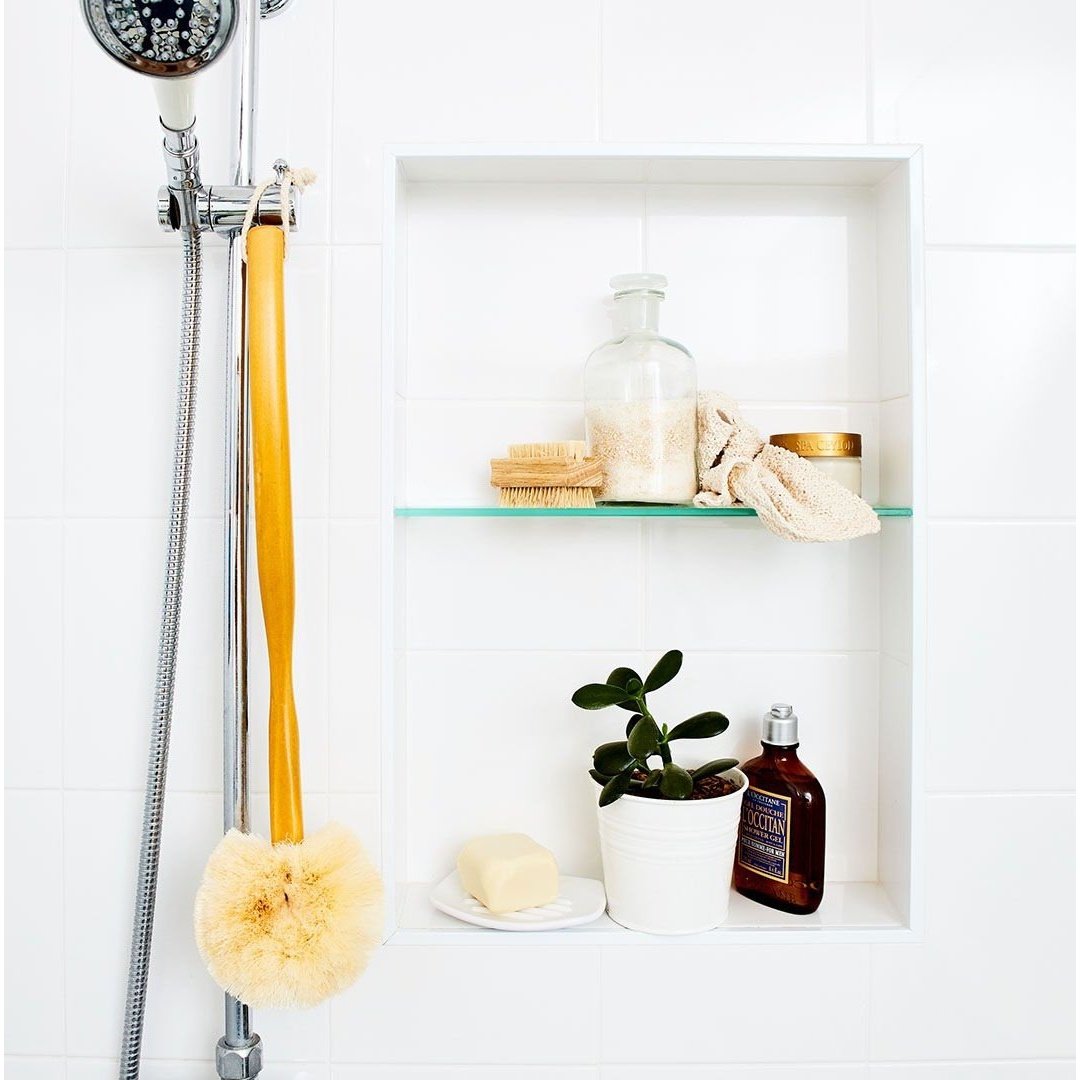 Long Handled Back Brush from Eco Max, Hanging in a Bathroom