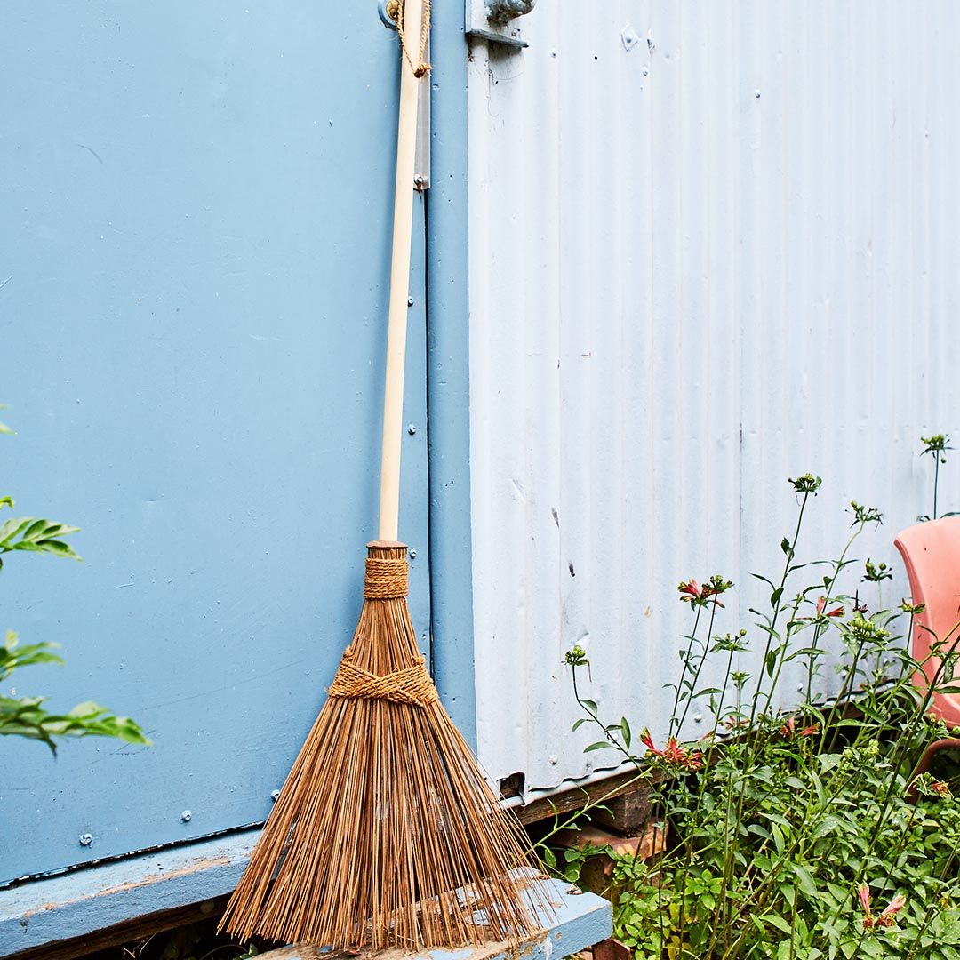 Palm Broom or Rake from Eco Max, Leaning Against a Wall