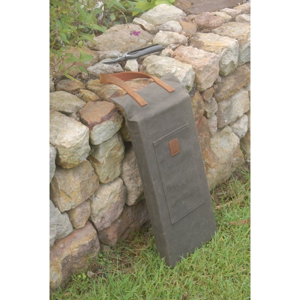 Waxed Canvas Kneeler with Leather Handle in a Garden