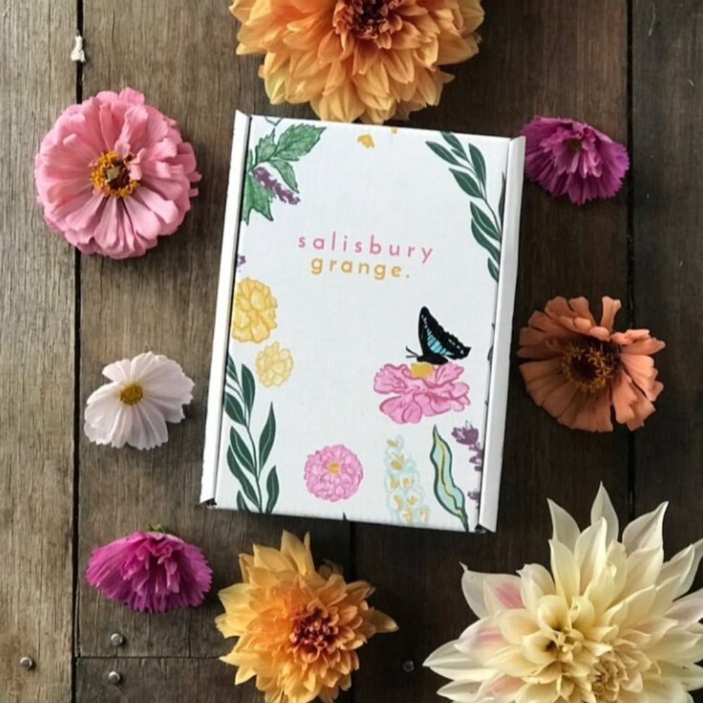 The Bee Friendly Gift Box by Salisbury Grange surrounded by flowers