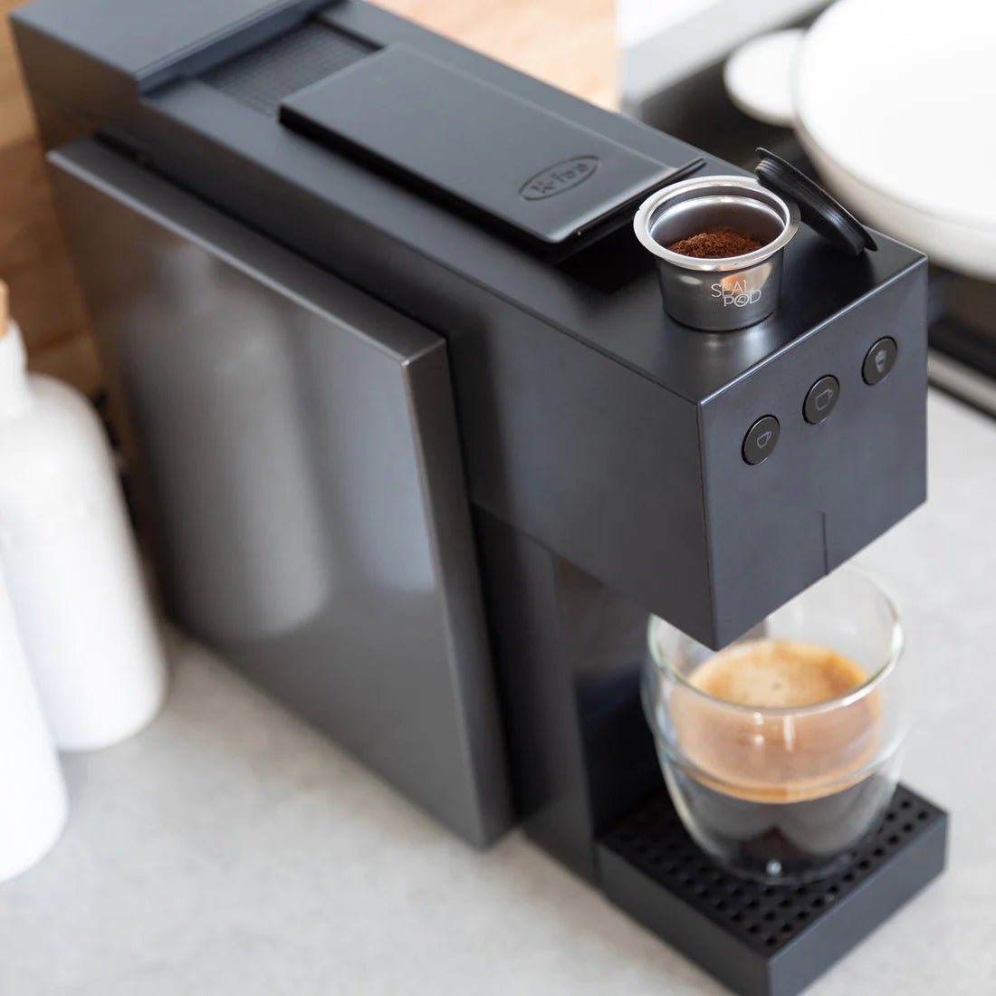 FeePod Capsule on top of Coffee Pod Machine